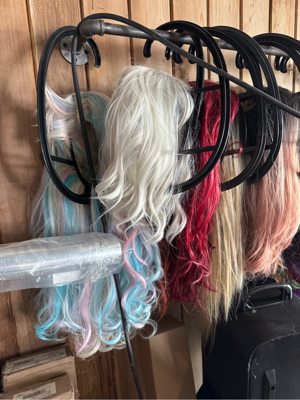 Collection of 13 unique wigs from bobs to long styles. Comes with the holders